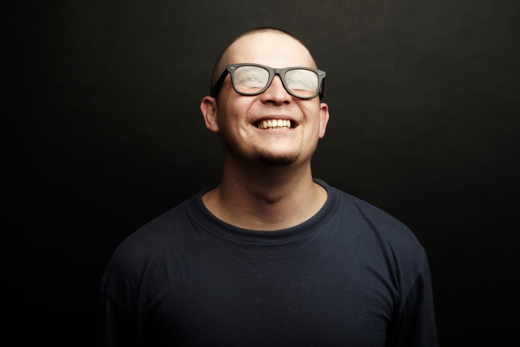 Man smiling on black background